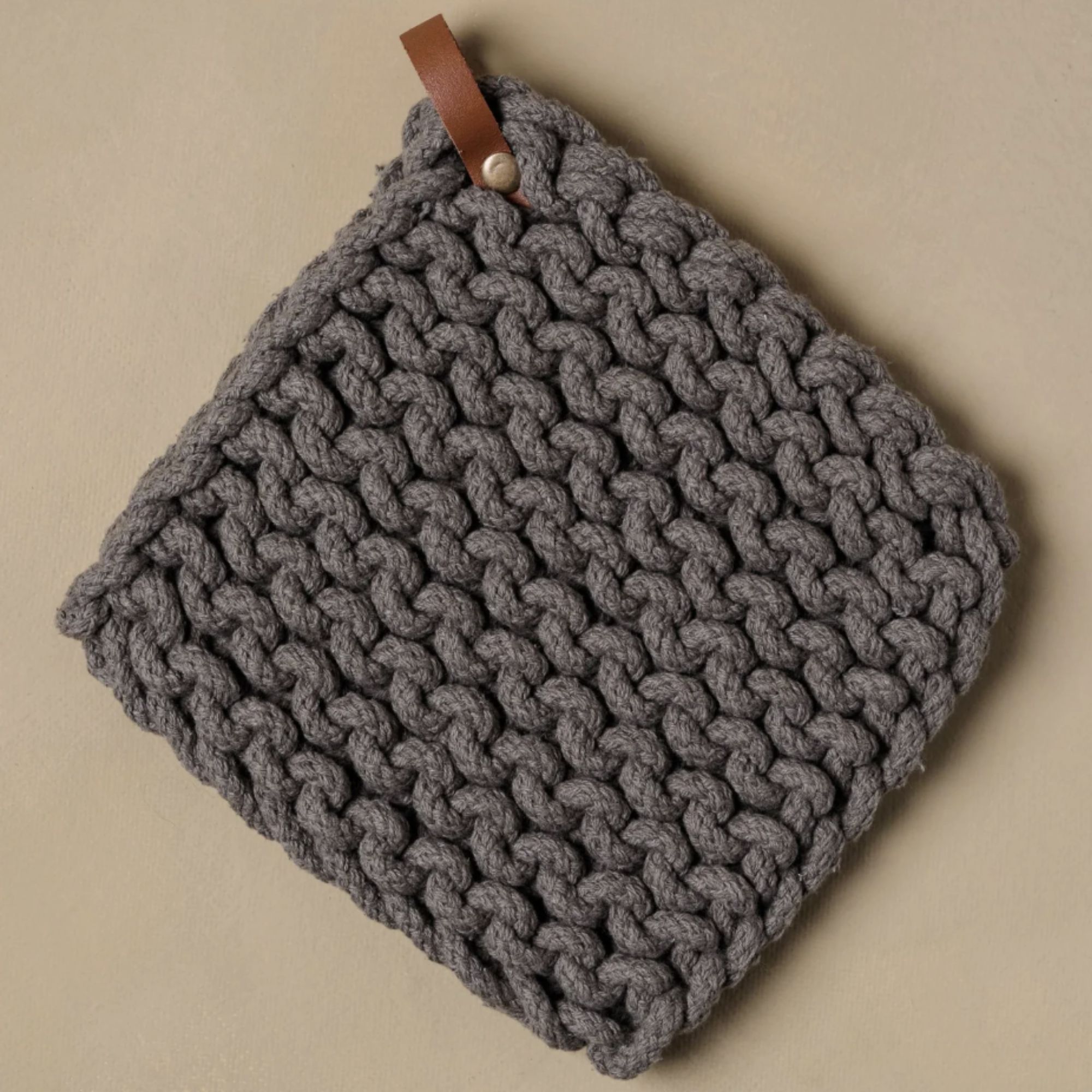 Gray crocheted pot holder with leather hook