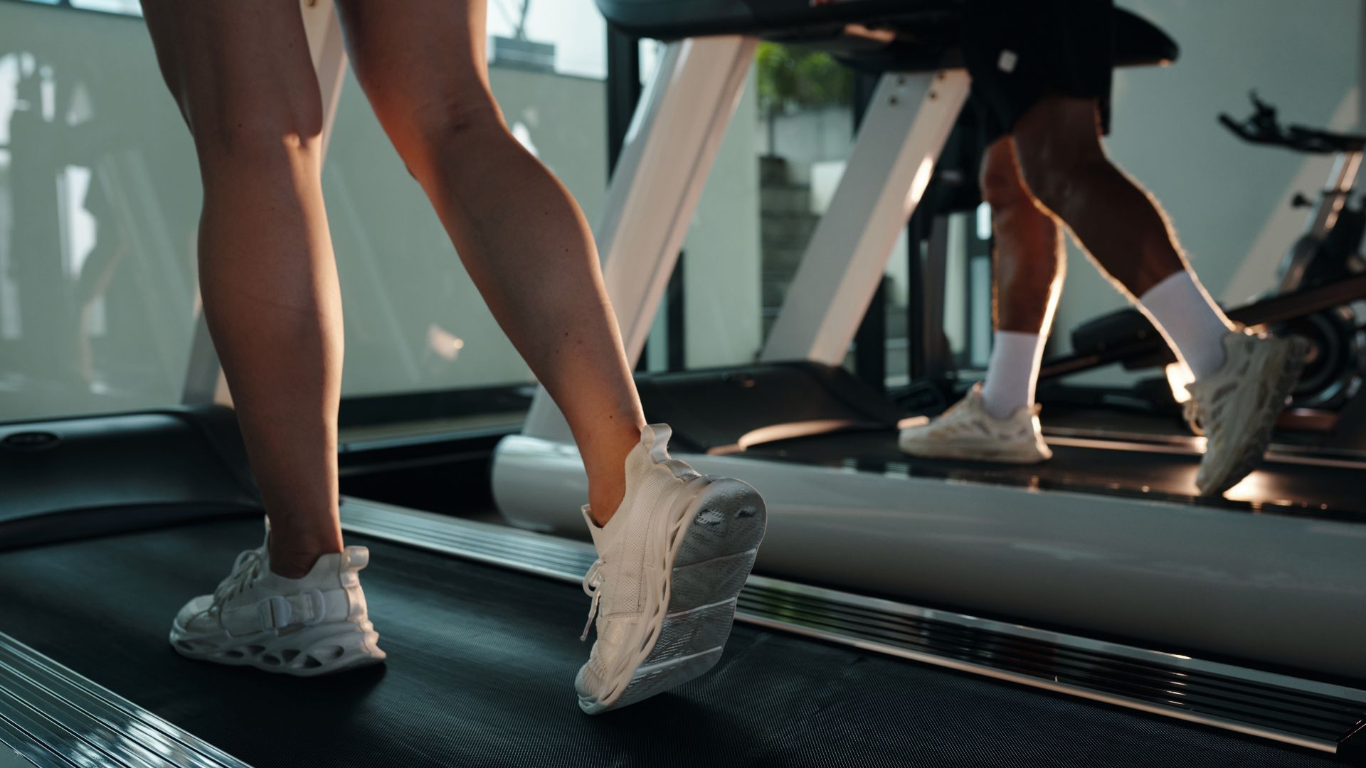 Woman's legs wearing trainers on a treadmill