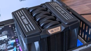 Close‑up of the Cooler Master V8 ACE 3DHP CPU cooler installed inside a test bench, showing its engine‑inspired shroud, curved heat pipes, and fin stack.