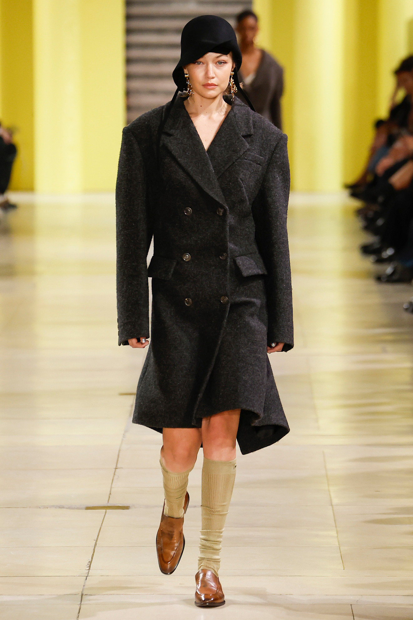 An image of a grey coat on Miu Miu's autumn/winter 2025 runway.