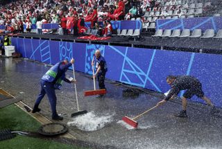 Stadium staff look to clear flooding during Turkey vs Georgia at Euro 2024