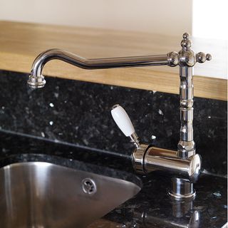 sink area with black worktop and tap