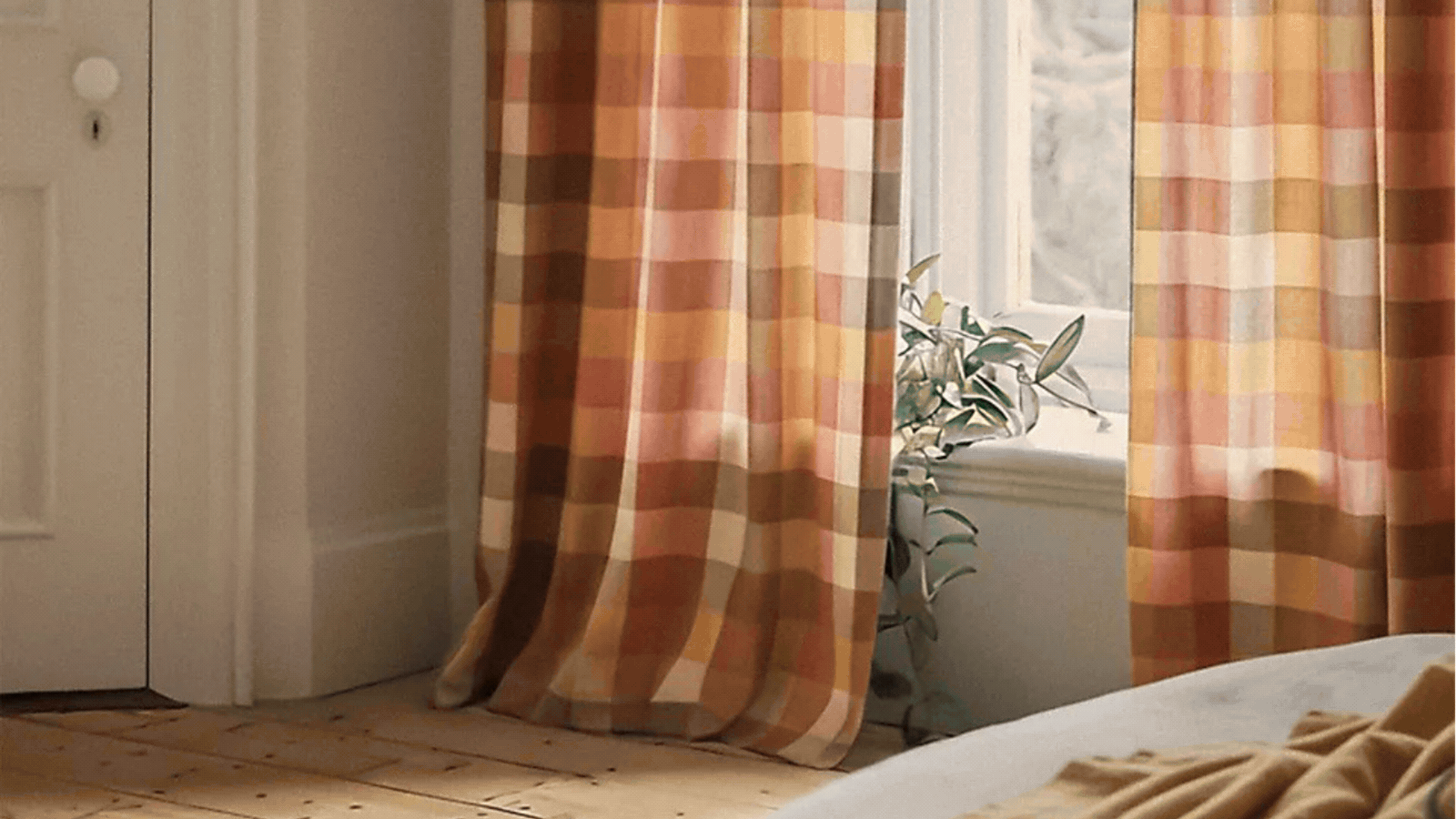 Roatating GIF of four images that show different curtains by Anthropologie. There is a pink plaid curtain, a black-and-white tweed curtain, and a white curtain with green scalloped edges. 