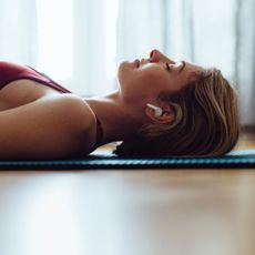 Coping techniques for anxiety: A woman lying down on a yoga mat
