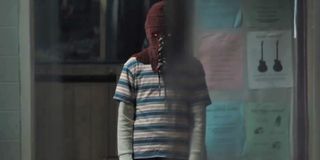 Brightburn Brandon standing in a room, looking menacing with his hood