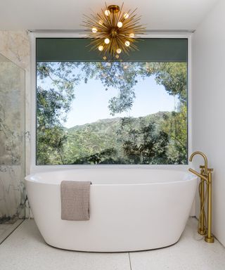 Mandy Moore's bathroom featuring a freestanding tub and abstract light fixture