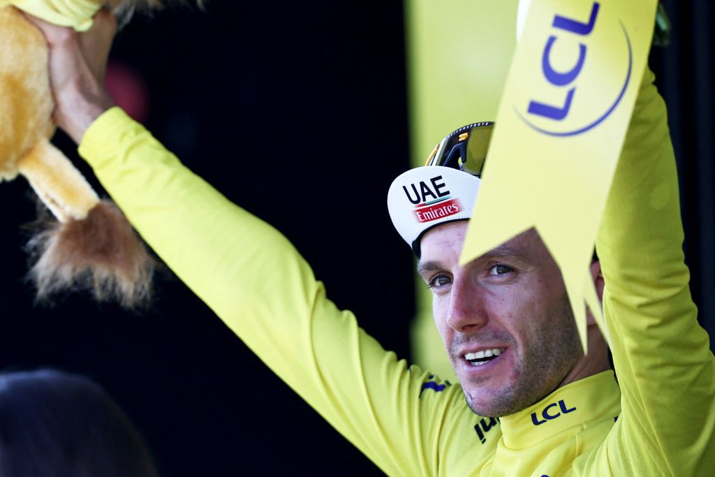 UAE Team Emirates British rider Adam Yates celebrates on the podium with the overall leaders yellow jersey after the 3rd stage of the 110th edition of the Tour de France cycling race 1935 km between AmorebietaEtxano in Northern Spain and Bayonne in southwestern France on July 3 2023 Photo by AnneChristine POUJOULAT AFP Photo by ANNECHRISTINE POUJOULATAFP via Getty Images