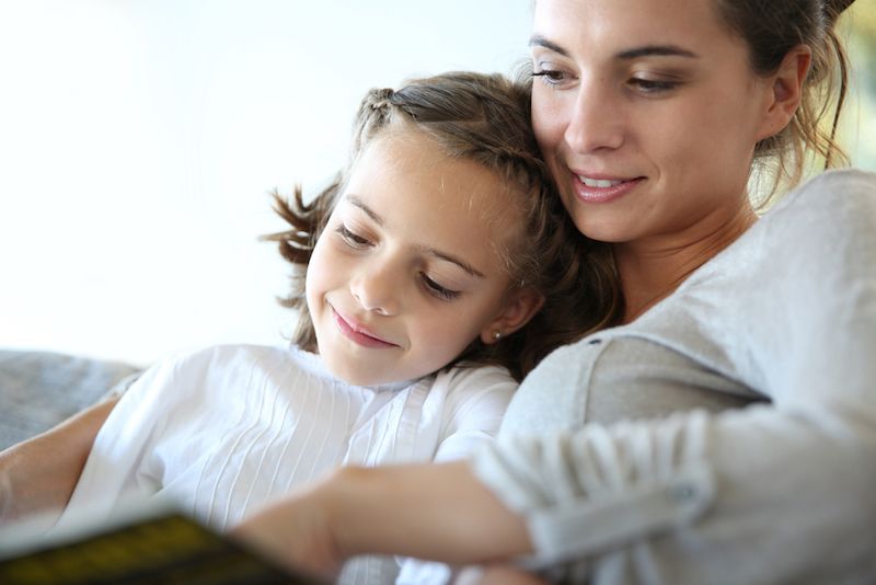 A mom reads to her daughter