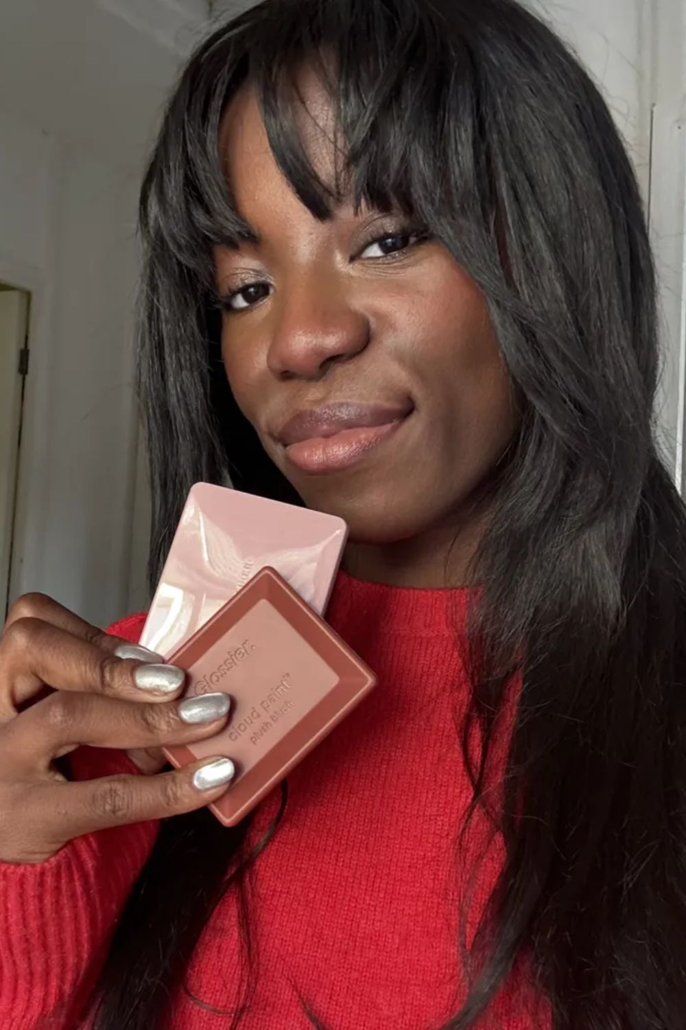Ata-Owaji Victor holding some of the best blushers for dark skin tones