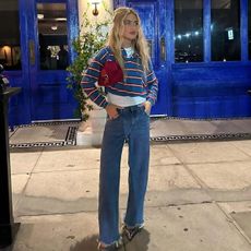 emili sindlev wearing a striped shirt and jeans