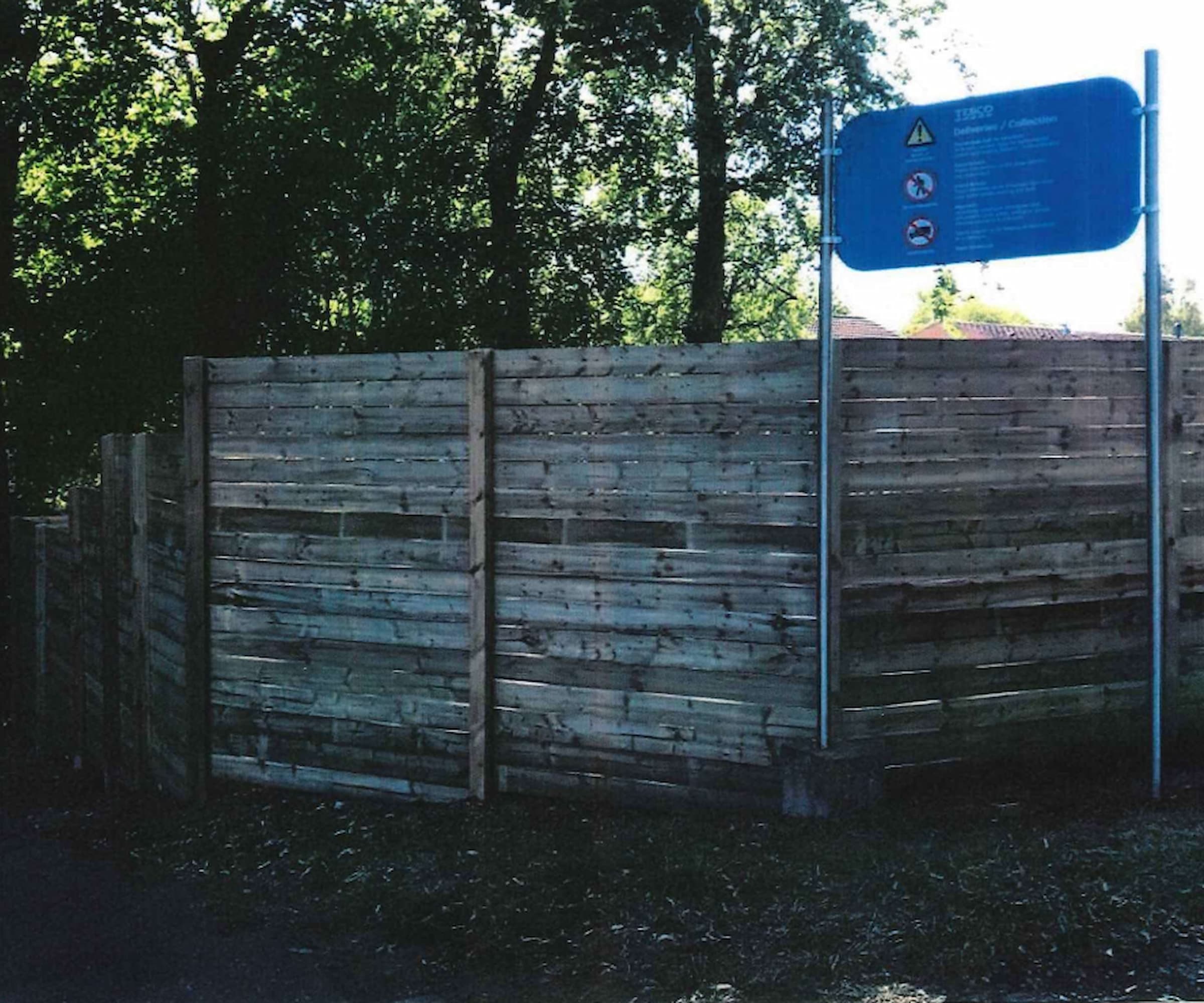 A timber fence on the corner of a road