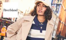 River Island logo placed over an image of a woman in a city with a hat on