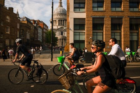 Commuters ride bikes in London