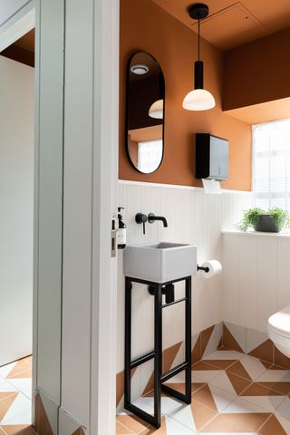 a small bathroom painted orange