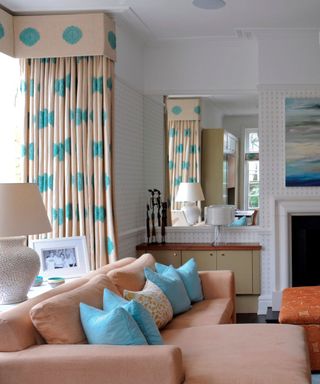 small white ditsy wallpaper in a bright living room with statement curtains