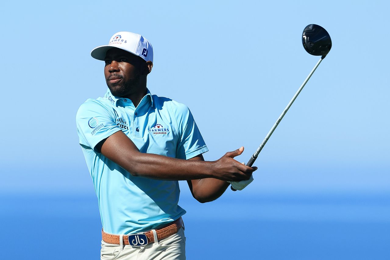 Kamaiu Johnson watches his tee shot with a driver