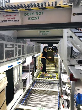Blair Bigelow, Bigelow Aerospace's Vice President of Corporate Strategy, gives a tour of the company's Mars Transporter Testing Unit on Sept. 12, 2019. (The "does not exist" tags point out pieces that would not be part of the real space habitat, which wouldn't need walkways and other gravity-related structural elements.)