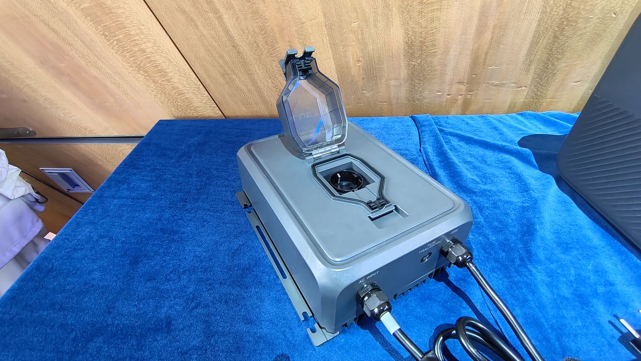A Bluetti Transfer Hub on display on a table with a blue tablecloth