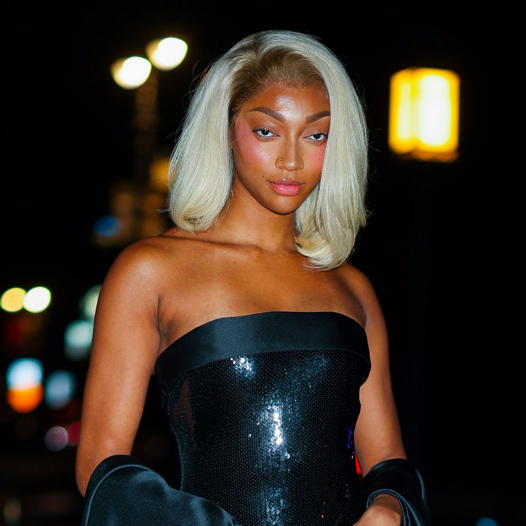 Angel Reese wearing a blond bob and looking at the camera
