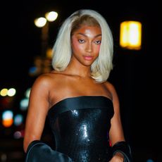 Angel Reese wearing a blond bob and looking at the camera