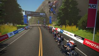 The riders pass under the finish banner at the men's Esport World Championships