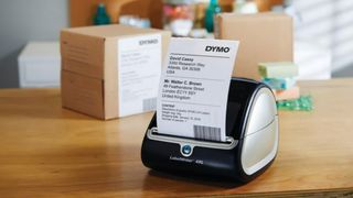 One of the best thermal printers is Dymo, as shown by one photographed on a wooden table