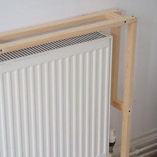white wall with radiator and wooden frame