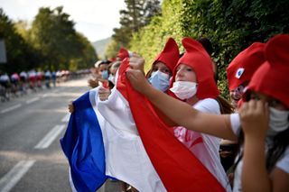 Children wave a French flag as they cheer for the riders during the 16th stage of the 107th edition of the Tour de France cycling race 164 km between La Tour du Pin and VillarddeLans on September 15 2020 Photo by AnneChristine POUJOULAT AFP Photo by ANNECHRISTINE POUJOULATAFP via Getty Images
