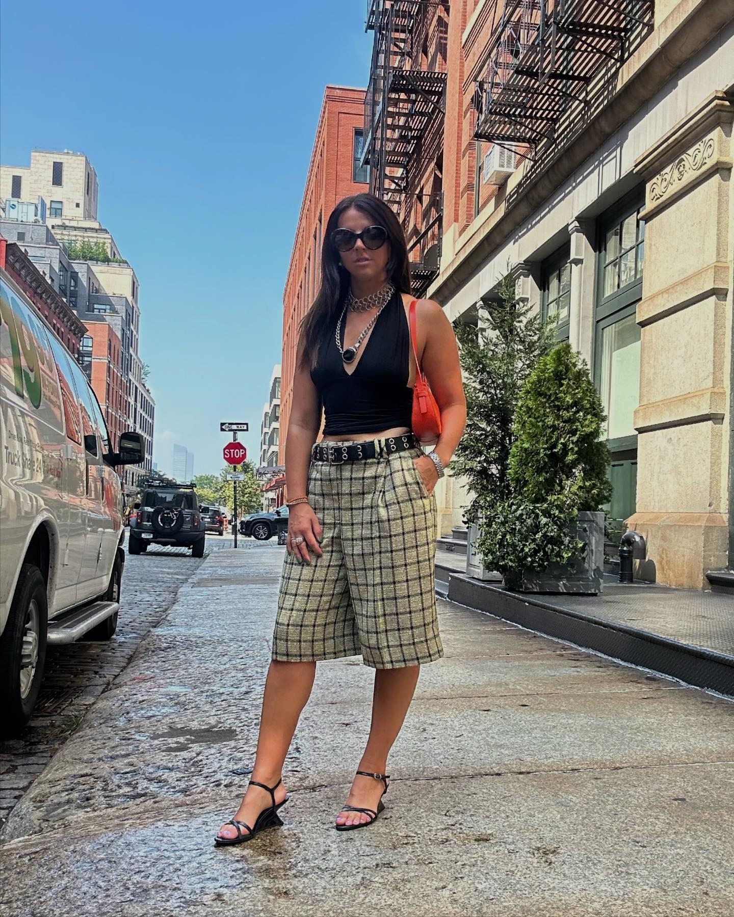 vanessa wears black halter top and plaid shorts with black wedges