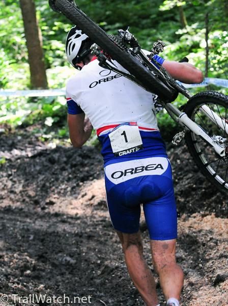 Julien Absalon (Orbea) running the mud while in the lead.