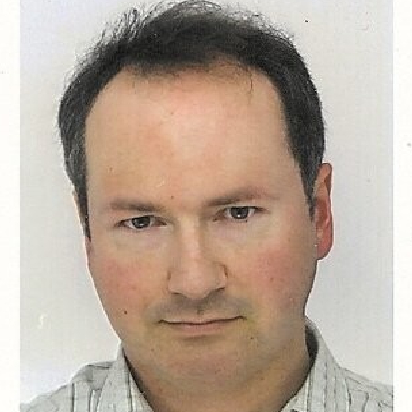 male with short dark hair wearing checked shirt