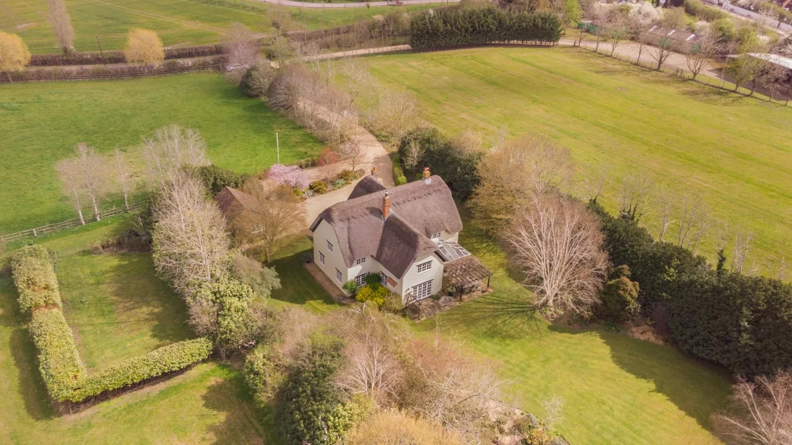 Aerial view of Strawberry farm, showing off the beautiful thatched roof and surrounding land.