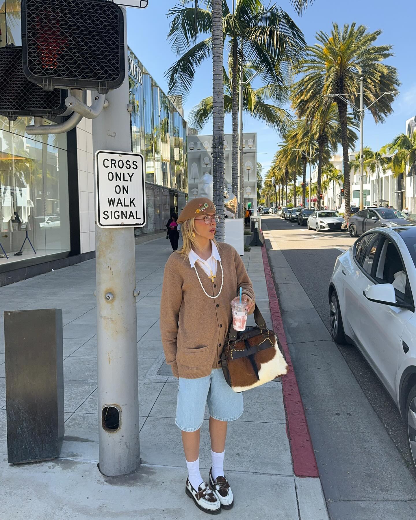 @sofiamcoelho wears cow print loafers with denim shorts