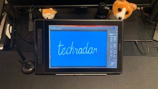 Huion Kamvas Pro 13 (2.5k) on a desk with the word TechRadar written