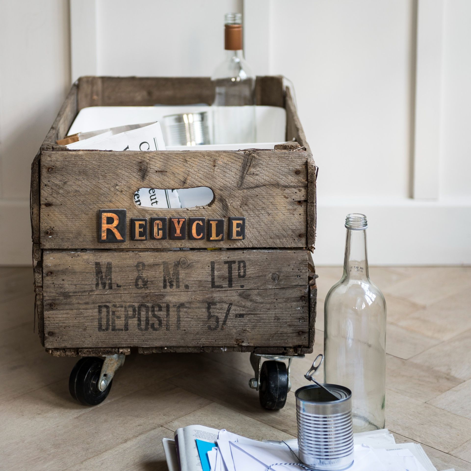 Recycling bin made of a wooden box on wheels
