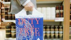 Man carrying a 'duty and tax free' shopping bag