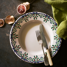 Mistletoe plate with knife and fork and dired oranges