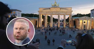 Visitors photograph Pariser Platz square and the Brandenburg Gate from atop a temporary viewing platform on May 19, 2015 in Berlin, Germany. Berlin is among Europe's major tourist and travel destinations. With an inset picture of Wayne Rooney taken in 2024