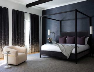 a bedroom with a dark accent wall