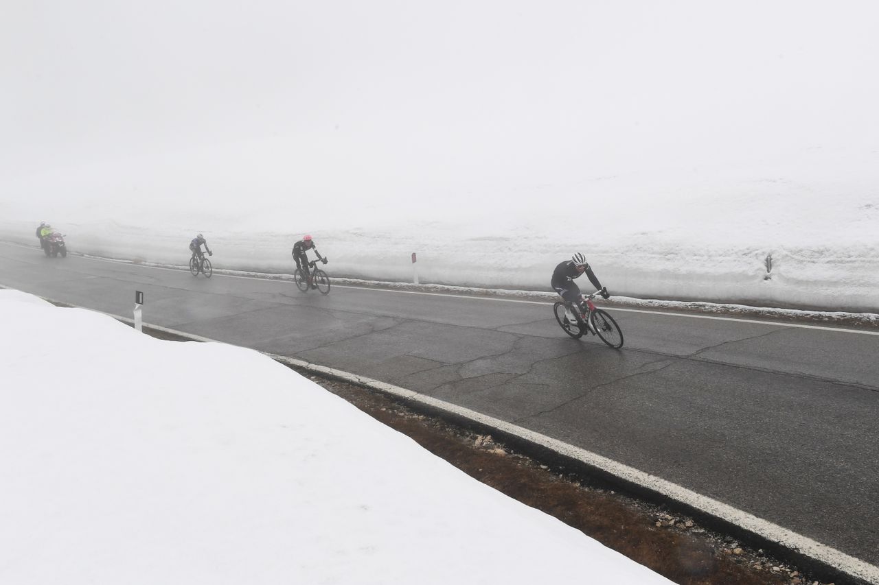 Riders coming through the fog on the top of the Passo Giau during stage 16 of the Giro d&#039;Italia 2021