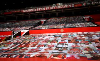 Fan pictures on banners covering the seats in the stands at Old Trafford