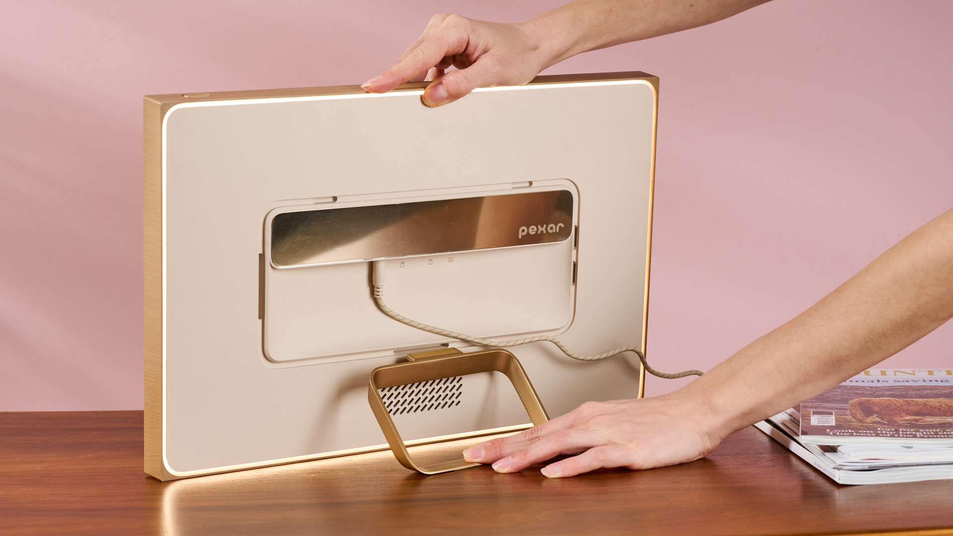 The rear of the Pexar Starlight 15.6-inch showing a person's hands fitting its stand into the given slot.