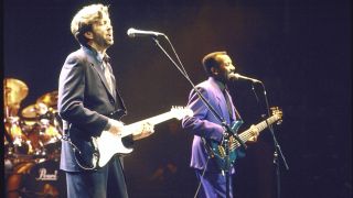 Blues guitarist Eric Clapton & jazz bassist Nathan East performing on stage.