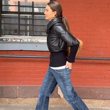 Woman in bootcut jeans and leather jacket