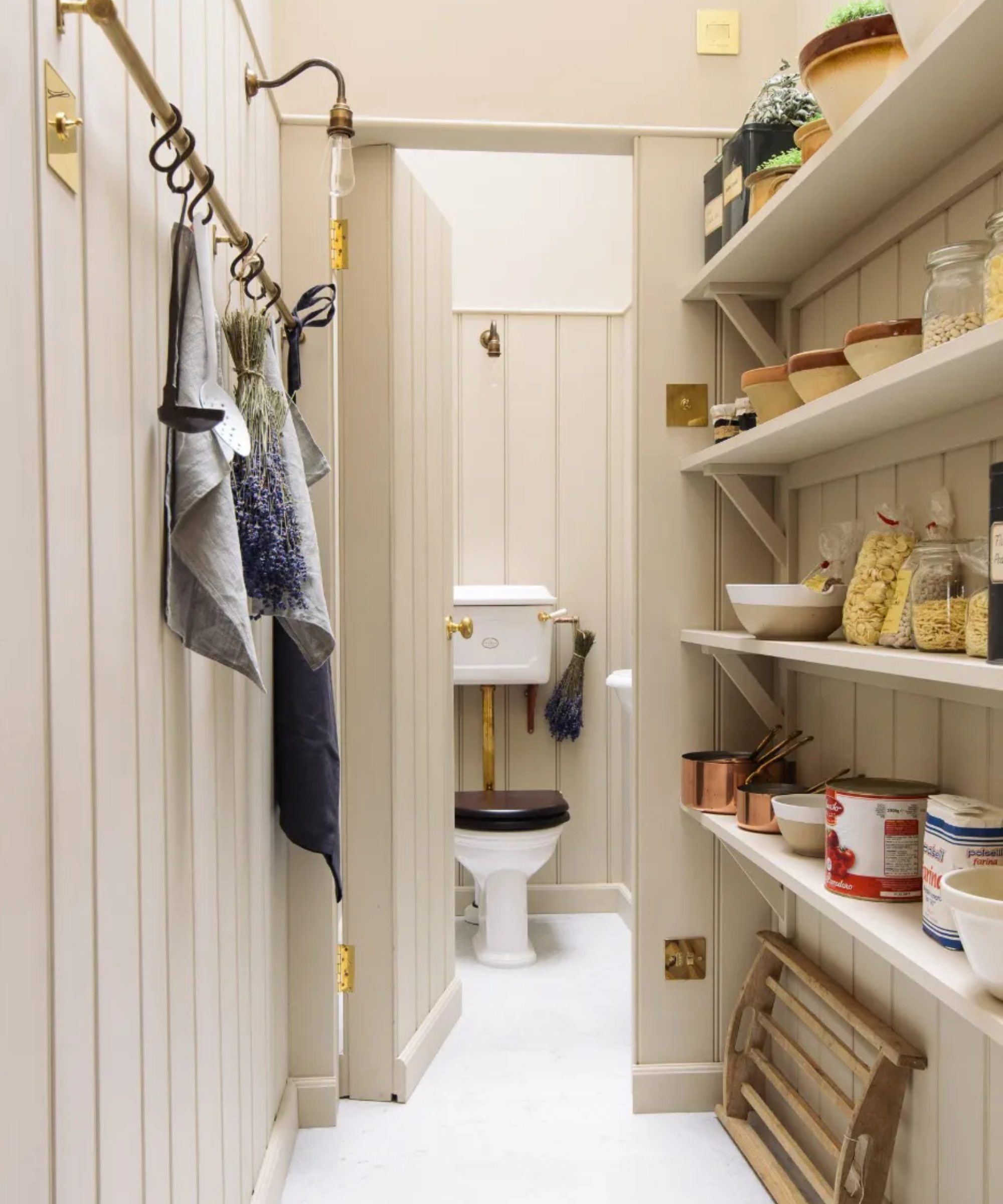 wc behind a panelled door in a pantry