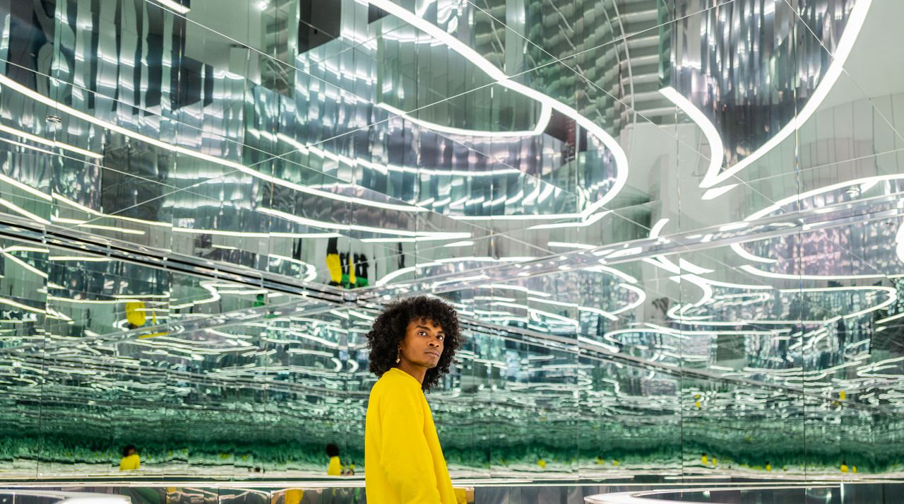 Person standing in a hall of mirrors