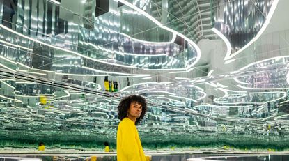 Person standing in a hall of mirrors