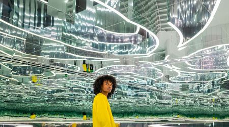 Person standing in a hall of mirrors