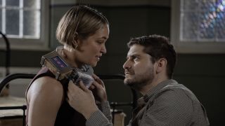 Travis attempting to remove bomb collar off Evie's neck in NCIS: Sydney