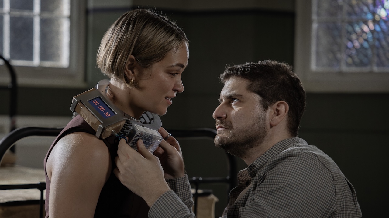 Travis attempting to remove bomb collar off Evie's neck in NCIS: Sydney